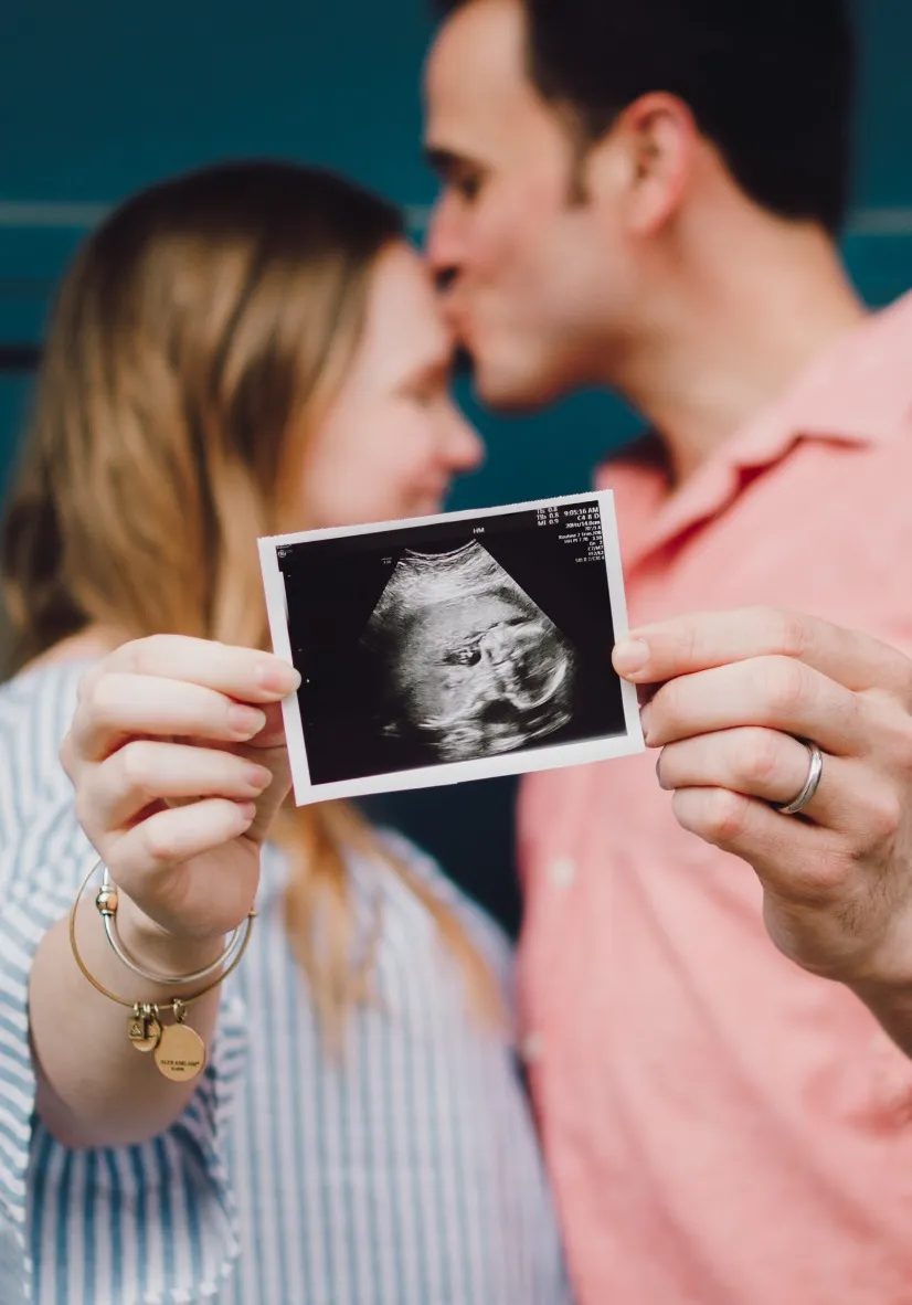 Couple holding baby ultrasound